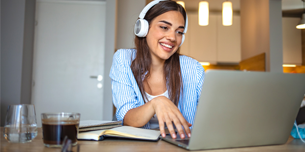 Student smiles while on the computer